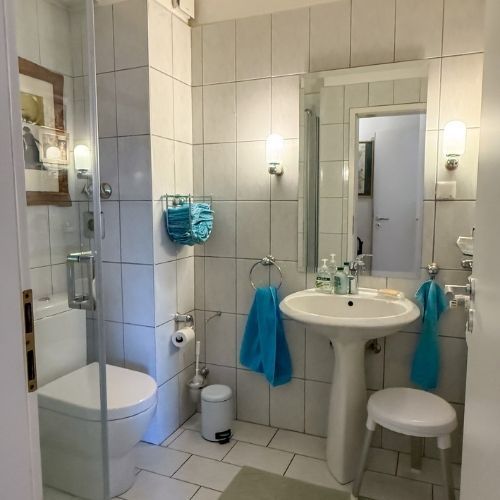 Modernes Gäste-Badezimmer mit Dusche, weißen Fliesen in einer Maisonette-Eigentumswohnung